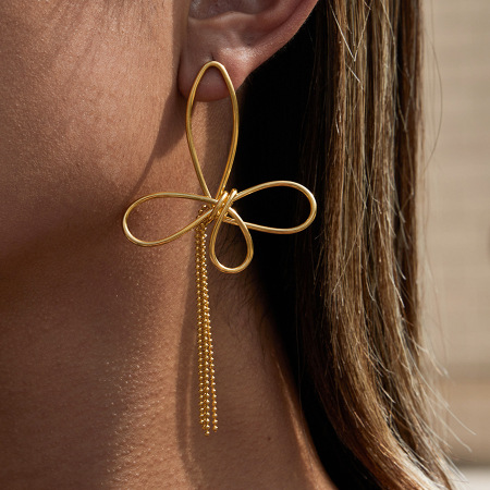 1 paire de magnifiques boucles d'oreilles pendantes pour femme, en acier inoxydable doré, avec nœud papillon et pompon. 2