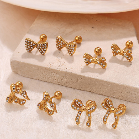 1 paire de boucles d'oreilles piercing en acier inoxydable doré, étanches, avec nœud papillon et strass.