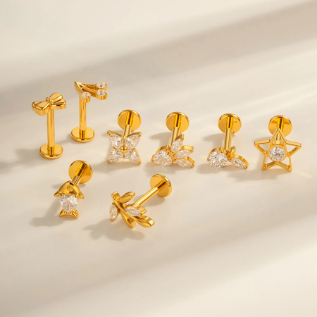 Boucles d'oreilles percées en forme d'étoile de mer brillante en alliage de titane couleur or et zircon pour femme