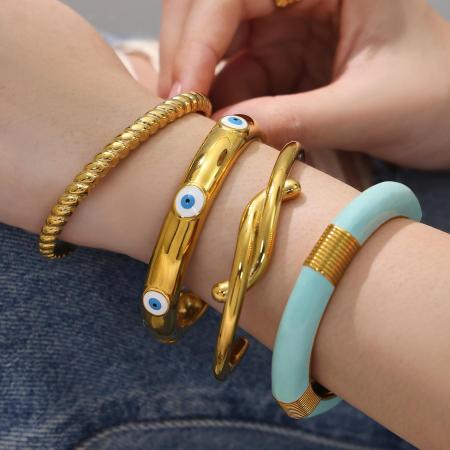 Bracelet manchette pour femme en acier inoxydable doré, imperméable, anti-ternissement, orné d'un motif œil du diable et d'un effet goutte d'huile.