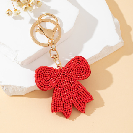 Porte-clés romantique en alliage tissé avec perles et nœud papillon, orné d'un nœud papillon doux et coloré.