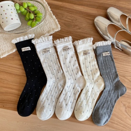 Chaussettes mi-mollet à pois élégants et légèrement rebondissants