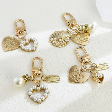 Porte-clés simple et décontracté en métal et perle artificielle, motif cœur, coquillage et étoile de mer, style océanique. Série simple.
